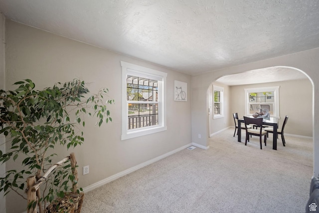 730 E 3155 S, Millcreek, UT 84106 - carpeted dining space featuring arched walkways, a textured ceiling, visible vents, and baseboards