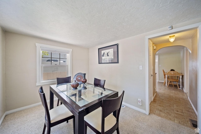730 E 3155 S, Millcreek, UT 84106 - dining room with light carpet, baseboards, arched walkways, and a textured ceiling