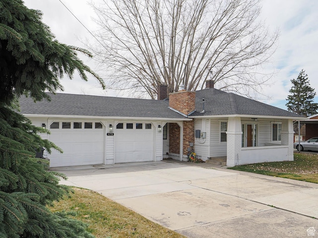 ranch-style home with driveway, a chimney, brick siding, and a garage
