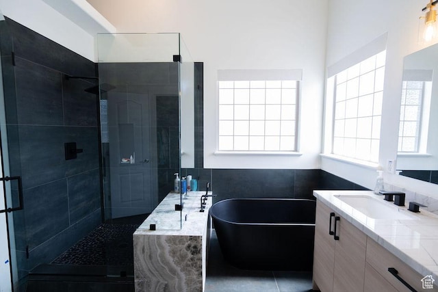 14661 S Rock Canyon Cir W, Herriman, UT 84096 - bathroom featuring a walk in shower, a soaking tub, vanity, and tile walls
