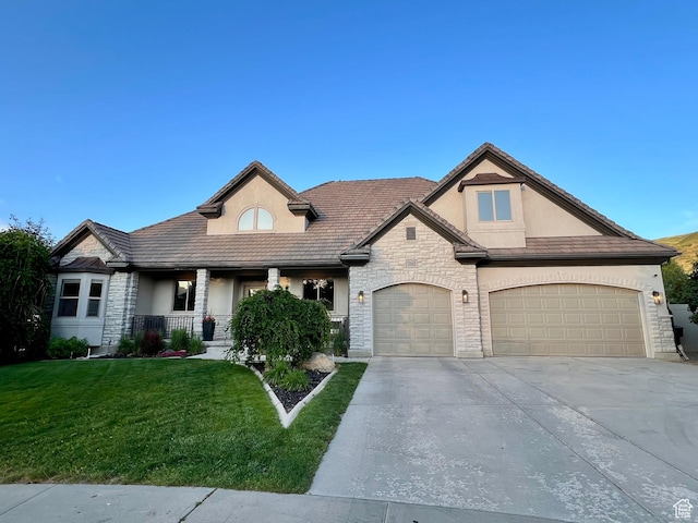 14661 S Rock Canyon Cir W, Herriman, UT 84096 - french country home featuring stone siding, stucco siding, driveway, and a front lawn