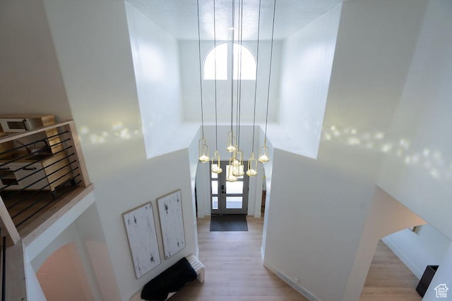 14661 S Rock Canyon Cir W, Herriman, UT 84096 - entrance foyer featuring light wood-style flooring, a chandelier, and healthy amount of natural light