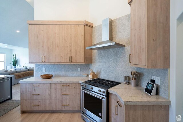 14661 S Rock Canyon Cir W, Herriman, UT 84096 - kitchen with stainless steel range with gas stovetop, light brown cabinets, wall chimney range hood, light wood-style flooring, and backsplash