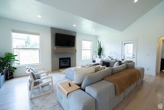 14661 S Rock Canyon Cir W, Herriman, UT 84096 - living area featuring plenty of natural light, light wood-style flooring, recessed lighting, a glass covered fireplace, and baseboards