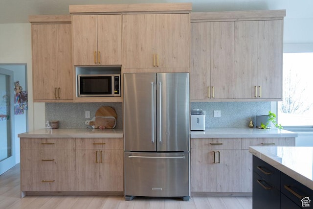 14661 S Rock Canyon Cir W, Herriman, UT 84096 - kitchen with stainless steel appliances, light brown cabinetry, tasteful backsplash, and light wood-type flooring