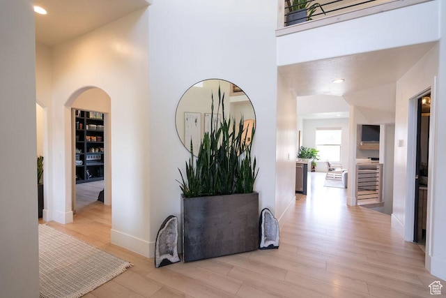14661 S Rock Canyon Cir W, Herriman, UT 84096 - hallway with light wood-type flooring, a high ceiling, baseboards, recessed lighting, and built in shelves