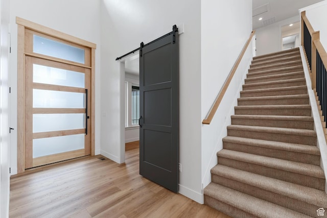 3010 W Willow Dr S, Lehi, UT 84043 - staircase with baseboards, visible vents, a barn door, and wood finished floors