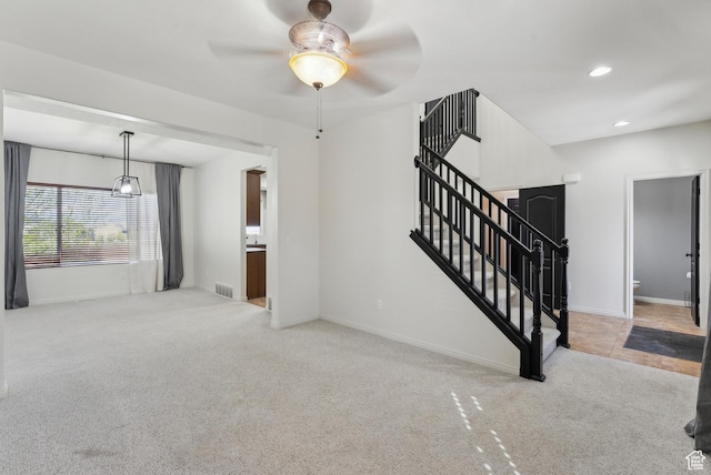 unfurnished living room with baseboards, recessed lighting, a ceiling fan, stairway, and carpet floors