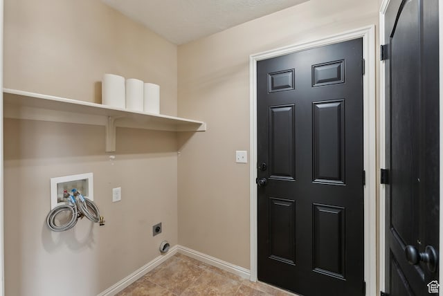 clothes washing area with hookup for a washing machine, baseboards, electric dryer hookup, and laundry area