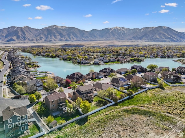 aerial view with a water and mountain view and a residential view
