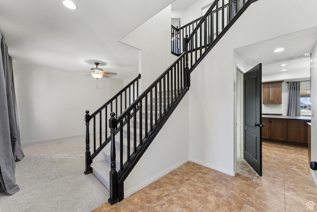stairway featuring a ceiling fan, baseboards, and recessed lighting