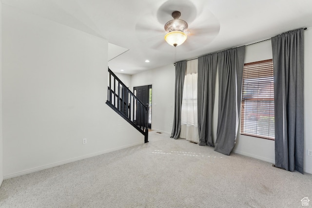 unfurnished room with recessed lighting, carpet, stairway, baseboards, and ceiling fan