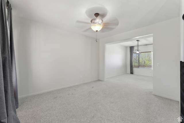 spare room featuring baseboards, a ceiling fan, and carpet flooring