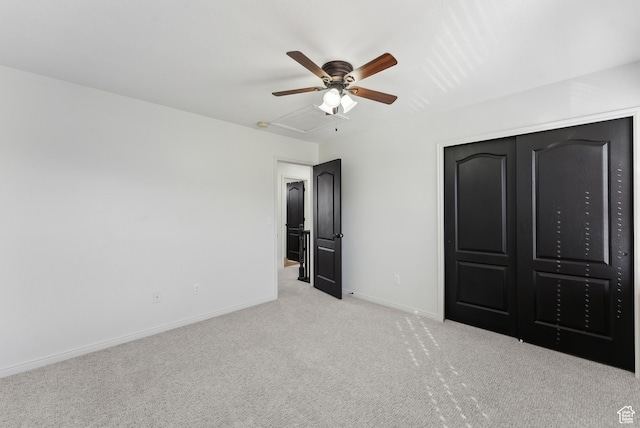 unfurnished bedroom with a ceiling fan, baseboards, carpet, and a closet