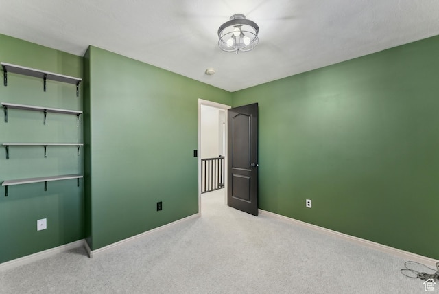 unfurnished bedroom featuring baseboards and carpet