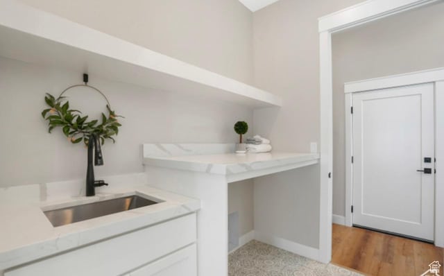 bar with baseboards and a sink