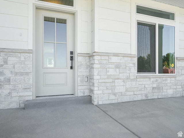 entrance to property featuring stone siding