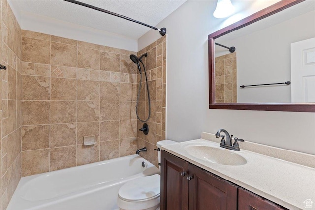 full bathroom featuring toilet, vanity, a textured ceiling, and shower / bath combination