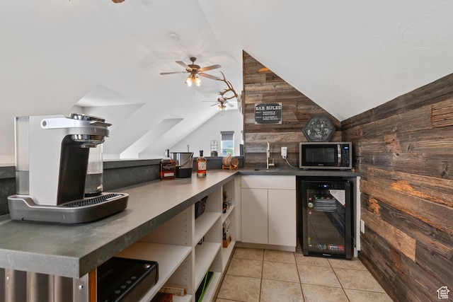 468 E 12000 S, Draper, UT 84020 - kitchen featuring vaulted ceiling, a ceiling fan, beverage cooler, stainless steel microwave, and wood walls