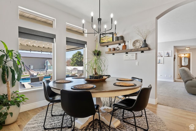 468 E 12000 S, Draper, UT 84020 - dining room with arched walkways, light wood finished floors, baseboards, and a notable chandelier