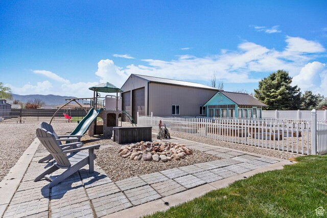 468 E 12000 S, Draper, UT 84020 - back of property with a playground, fence, an outdoor structure, a fire pit, and a mountain view
