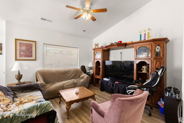 2261 S Tonaquint Dr W Unit 55, St George, UT 84770 - living room featuring light wood-style floors, vaulted ceiling, visible vents, and a ceiling fan