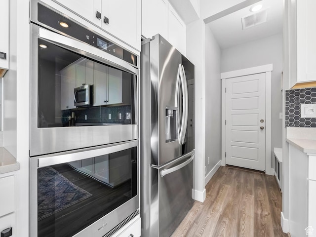 1058 S 800 W, American Fork, UT 84003 - kitchen with wood finished floors, backsplash, stainless steel refrigerator with ice dispenser, white cabinetry, and visible vents