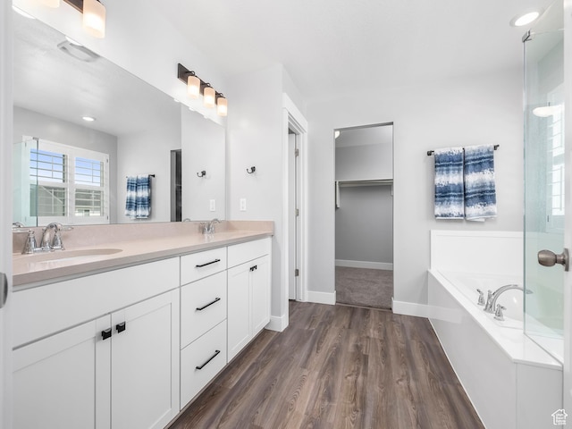 1058 S 800 W, American Fork, UT 84003 - bathroom featuring double vanity, wood finished floors, a garden tub, and a sink