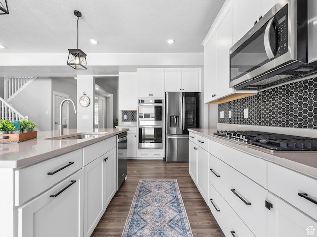 1058 S 800 W, American Fork, UT 84003 - kitchen with stainless steel appliances, a sink, tasteful backsplash, white cabinetry, and light countertops