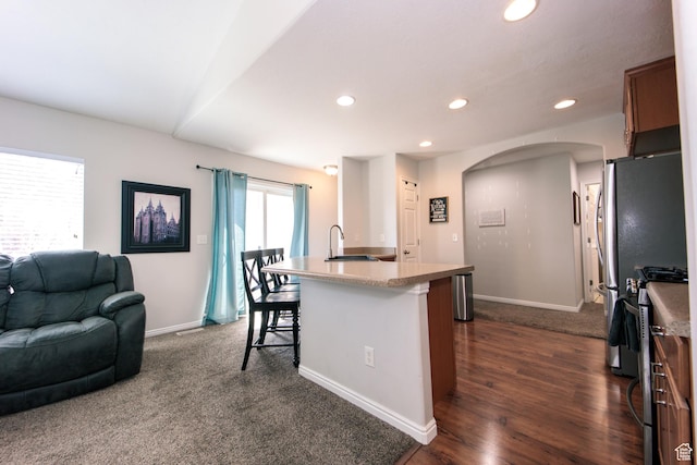 3611 W 850 S, Syracuse, UT 84075 - kitchen with a sink, open floor plan, recessed lighting, a kitchen bar, and range