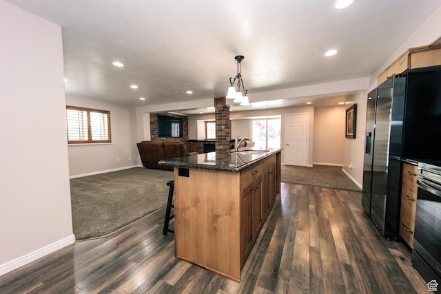 3611 W 850 S, Syracuse, UT 84075 - kitchen with a sink, open floor plan, a breakfast bar, dark wood finished floors, and baseboards
