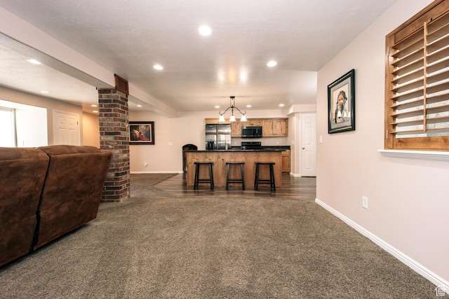 3611 W 850 S, Syracuse, UT 84075 - living area with recessed lighting, dark colored carpet, baseboards, and ornate columns