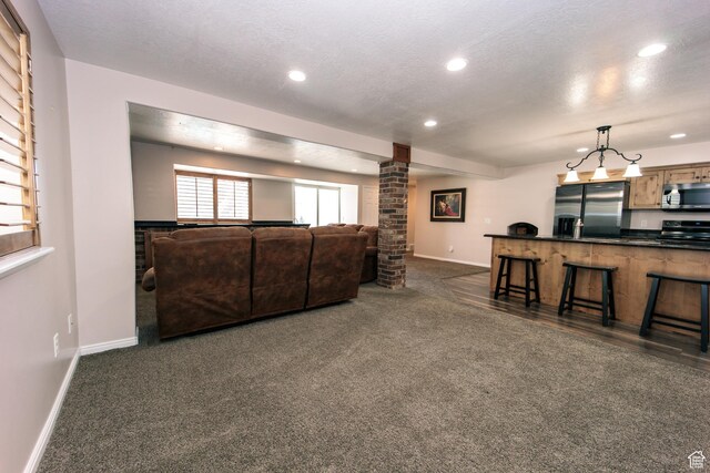 3611 W 850 S, Syracuse, UT 84075 - living area with recessed lighting, dark carpet, baseboards, and ornate columns