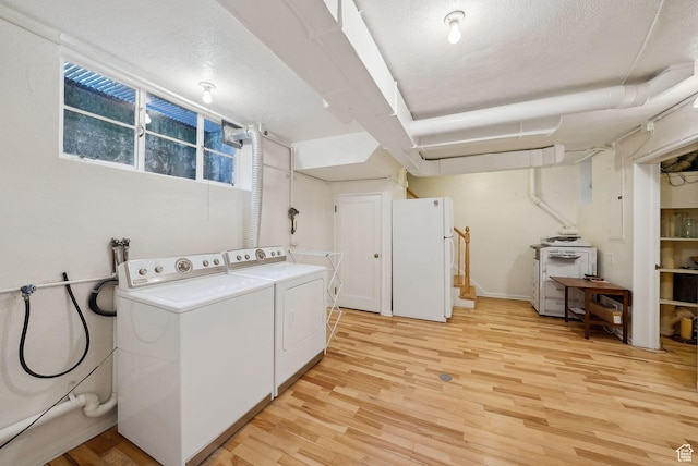 1500 E Arlington Dr, Salt Lake City, UT 84103 - laundry area featuring washer and dryer, a textured ceiling, and light wood-type flooring