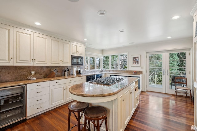 1500 E Arlington Dr, Salt Lake City, UT 84103 - kitchen with beverage cooler, dark wood-style floors, gas cooktop, black microwave, and tasteful backsplash