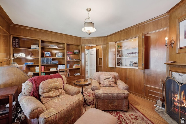 1500 E Arlington Dr, Salt Lake City, UT 84103 - living room featuring built in shelves, wood finished floors, crown molding, wooden walls, and a high end fireplace