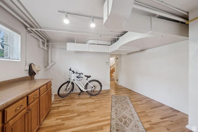 1500 E Arlington Dr, Salt Lake City, UT 84103 - basement with light wood-style flooring, rail lighting, and stairway
