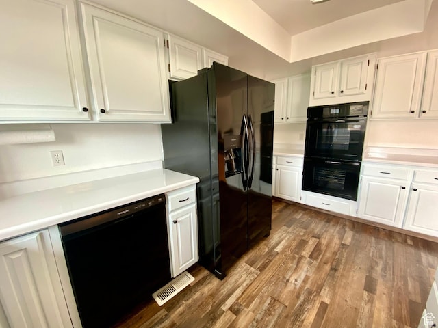 155 W 350 S, Glenwood, UT 84730 - kitchen with dark wood finished floors, visible vents, white cabinetry, light countertops, and black appliances