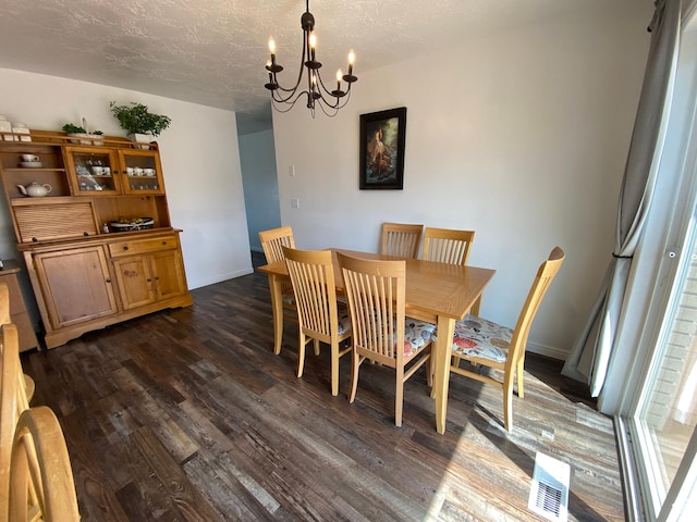 155 W 350 S, Glenwood, UT 84730 - dining area with dark wood-style floors, a textured ceiling, baseboards, a notable chandelier, and visible vents