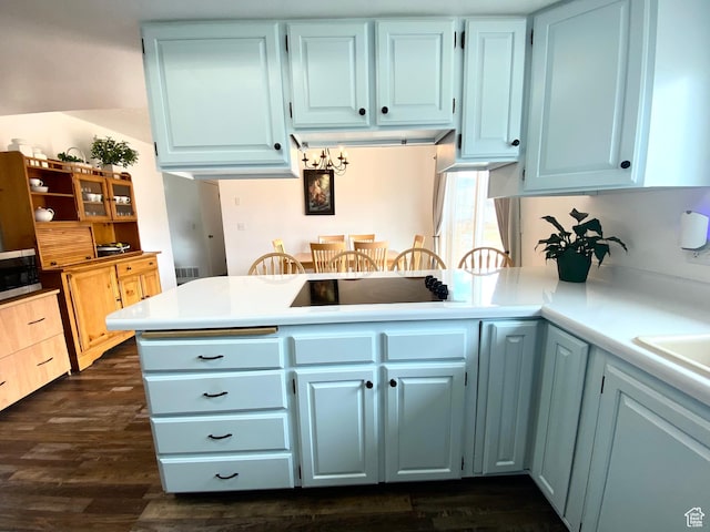 155 W 350 S, Glenwood, UT 84730 - kitchen with black electric stovetop, light countertops, stainless steel microwave, a peninsula, and dark wood-style flooring