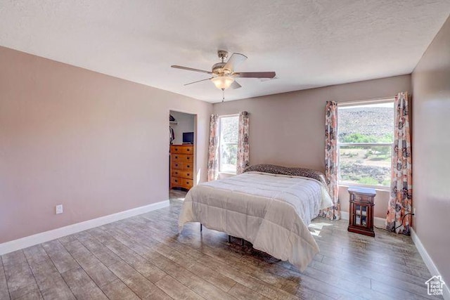 715 S Peachtree Dr, Toquerville, UT 84774 - bedroom featuring baseboards, a ceiling fan, and wood finished floors