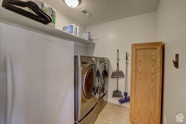 715 S Peachtree Dr, Toquerville, UT 84774 - laundry area with washing machine and dryer, visible vents, light tile patterned floors, and laundry area