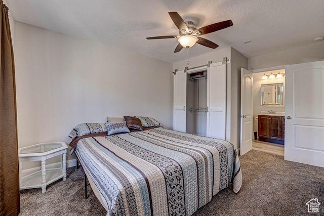 715 S Peachtree Dr, Toquerville, UT 84774 - bedroom featuring a barn door, a ceiling fan, connected bathroom, carpet floors, and baseboards