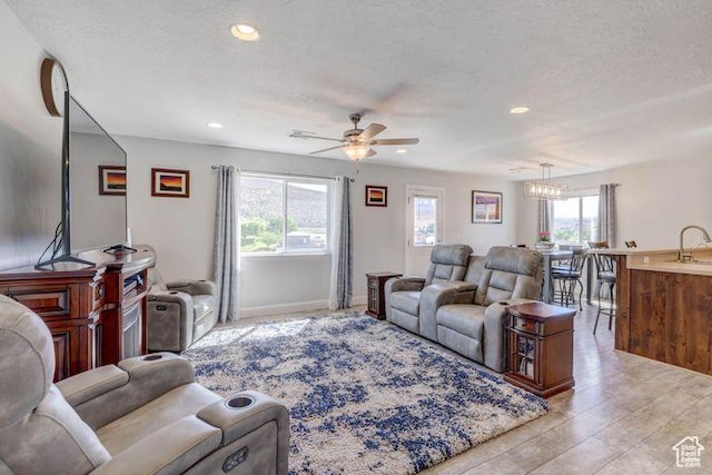 715 S Peachtree Dr, Toquerville, UT 84774 - living room with ceiling fan with notable chandelier, light wood-style flooring, and recessed lighting