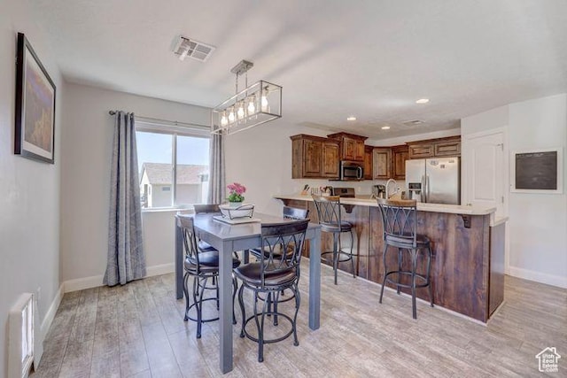 715 S Peachtree Dr, Toquerville, UT 84774 - dining area with visible vents, light wood finished floors, and baseboards