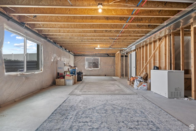 below grade area featuring fridge