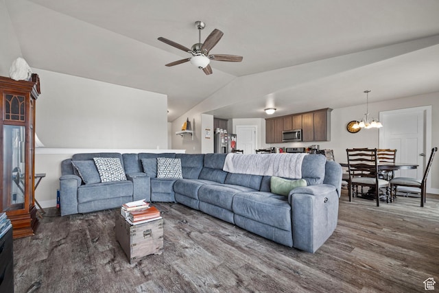living area with wood finished floors, lofted ceiling, baseboards, and ceiling fan with notable chandelier