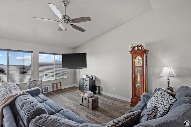 living area with lofted ceiling, baseboards, wood finished floors, and ceiling fan