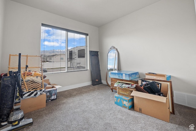 interior space with baseboards, visible vents, and carpet flooring