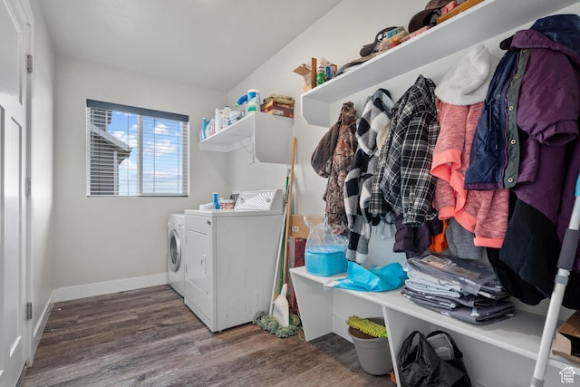 washroom with wood finished floors, washer and clothes dryer, baseboards, and laundry area